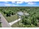 Single-story house on a lot with a paved driveway and trees at 221 Evergreen St, Punta Gorda, FL 33982
