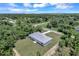 Single-story house nestled in a wooded area with a paved driveway at 221 Evergreen St, Punta Gorda, FL 33982