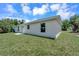 Side view of the house with a grassy lawn and some trees at 221 Evergreen St, Punta Gorda, FL 33982