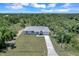 Single-story house on a large lot with a paved driveway at 221 Evergreen St, Punta Gorda, FL 33982