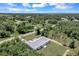 Aerial view of a single-story home with a large backyard and surrounding trees at 221 Evergreen St, Punta Gorda, FL 33982