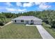 Single-story home with gray roof and driveway at 221 Evergreen St, Punta Gorda, FL 33982