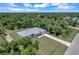 Single-story house surrounded by lush greenery, paved driveway at 221 Evergreen St, Punta Gorda, FL 33982