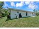 Rear view of the house showcasing the backyard and utilities at 221 Evergreen St, Punta Gorda, FL 33982