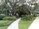 Curved walkway winds through lush landscaping and trees at 2125 Canal Dr # B23, Bradenton, FL 34207