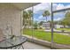 Private screened patio overlooking lush landscaping and a pool at 3245 Beneva Rd # 104, Sarasota, FL 34232