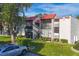 Condo building showcasing multiple units with red tile roofs and lush landscaping at 3245 Beneva Rd # 104, Sarasota, FL 34232