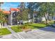 Condo building exterior showcasing a tiled roof, screened patios, and ample parking at 3245 Beneva Rd # 104, Sarasota, FL 34232