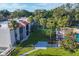 Aerial view shows the community pool, buildings, and lush grounds at 3245 Beneva Rd # 104, Sarasota, FL 34232