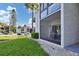 Exterior view of building with screened patio and landscaping at 3245 Beneva Rd # 104, Sarasota, FL 34232