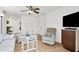 Living room boasts wood floors, comfortable seating and a large TV at 3245 Beneva Rd # 104, Sarasota, FL 34232