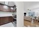 Open kitchen with granite countertops, dark wood cabinets and stainless steel appliances at 3245 Beneva Rd # 104, Sarasota, FL 34232