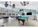 Bright community room with pool table, seating, and big screen TV at 3245 Beneva Rd # 104, Sarasota, FL 34232