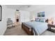 Bright bedroom with wooden bed frame and ensuite bathroom at 3245 Beneva Rd # 104, Sarasota, FL 34232