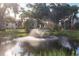 Peaceful pond with a central fountain at 3245 Beneva Rd # 104, Sarasota, FL 34232