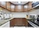 Kitchen features granite countertops and dark wood cabinets at 3245 Beneva Rd # 104, Sarasota, FL 34232