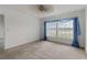 Bedroom with large window and neutral carpeting at 4113 Putter Pl, Bradenton, FL 34203