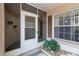 Screened entryway with sliding glass door and potted plants at 4113 Putter Pl, Bradenton, FL 34203