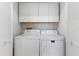 Laundry room with washer, dryer, and overhead cabinets at 4113 Putter Pl, Bradenton, FL 34203
