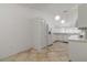 White kitchen with tile floor and breakfast nook at 4113 Putter Pl, Bradenton, FL 34203