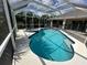 Relaxing pool and spa with a screened enclosure and patio access at 139 Long Meadow Lane Ln, Rotonda West, FL 33947