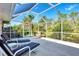Relaxing screened patio with lounge chairs, perfect for outdoor enjoyment at 139 Long Meadow Lane Ln, Rotonda West, FL 33947