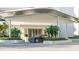 Modern building entrance with covered carport and landscaping at 555 Quay Cmn # 803, Sarasota, FL 34236
