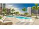 Modern rooftop pool deck with lounge chairs and city views at 555 Quay Cmn # 803, Sarasota, FL 34236