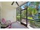 Screened porch with pink chairs and a view of the backyard at 341 Cape Harbour Loop # 105, Bradenton, FL 34212