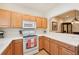 Modern kitchen features light wood cabinets, updated appliances, and a breakfast bar at 341 Cape Harbour Loop # 105, Bradenton, FL 34212
