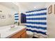 Clean bathroom with blue striped shower curtain and wood vanity at 341 Cape Harbour Loop # 105, Bradenton, FL 34212