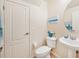 Small bathroom with white vanity, toilet, and oval mirror at 341 Cape Harbour Loop # 105, Bradenton, FL 34212