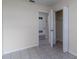 Well-lit bedroom with a closet and door to the hallway at 8172 Boca Grande Ave, North Port, FL 34287