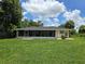 Single story home with screened porch and large backyard at 4373 Watova Ave, North Port, FL 34286