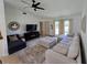 Open living room with sectional sofa and a large TV at 4373 Watova Ave, North Port, FL 34286