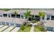 Aerial view showcasing gray condos with tile roofs, well manicured landscaping, and paved walkways on a sunny day at 17445 Opal Sand Dr # 104, Venice, FL 34293