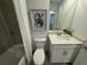 Clean bathroom featuring a bathtub with shower, a modern vanity, and decorative wall art at 17445 Opal Sand Dr # 104, Venice, FL 34293