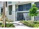 Exterior of a condo building showcasing a screened-in porch and well-maintained landscaping at 17445 Opal Sand Dr # 104, Venice, FL 34293