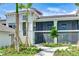 Exterior of a condo building showcasing a screened-in porch and well-maintained landscaping at 17445 Opal Sand Dr # 104, Venice, FL 34293