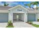 Spacious garage featuring an open door with a view to the home's entryway at 17445 Opal Sand Dr # 104, Venice, FL 34293