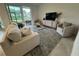 Cozy living room featuring a comfortable sofa, armchairs, and a view of the outdoor patio at 17445 Opal Sand Dr # 104, Venice, FL 34293