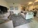 Comfortable living area with modern decor, sofa, armchairs, and natural lighting with views of kitchen at 17445 Opal Sand Dr # 104, Venice, FL 34293