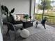 Outdoor patio with wicker furniture, a rug, and a view of lush greenery and landscaping at 17445 Opal Sand Dr # 104, Venice, FL 34293