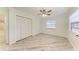 Bedroom with wood-look floors, window, and built-in closet at 2601 13Th W St, Palmetto, FL 34221