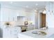 Bright white kitchen with marble countertops and high-end appliances at 455 Longboat Club Rd # 807, Longboat Key, FL 34228