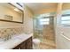 Bathroom featuring tiled shower, vanity with granite countertop, and updated fixtures at 5111 Coral Blvd, Bradenton, FL 34210