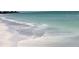 Calm ocean waves gently rolling onto the pristine, light-colored sandy beach at 5111 Coral Blvd, Bradenton, FL 34210