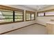 Bright bedroom featuring a ceiling fan, neutral carpet, and three windows with water views at 5111 Coral Blvd, Bradenton, FL 34210