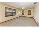 Spacious carpeted bedroom with bright natural light, ceiling fan, and multiple windows at 5111 Coral Blvd, Bradenton, FL 34210