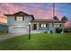 Charming two-story home boasting a manicured lawn and attached garage at 5111 Coral Blvd, Bradenton, FL 34210